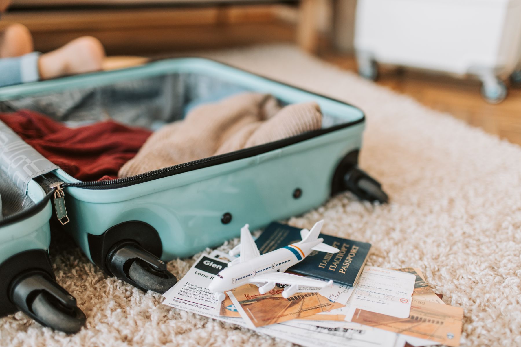 An open suitcase packed with essentials, ready for a fresh start.